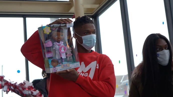 Buffalo Bills player Damar Hamlin holds up a packaged toy in a still image from his 2020 toy drive v...