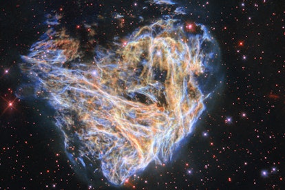 Shreds of the colorful supernova remnant DEM L 190 seem to billow across the screen in this image fr...