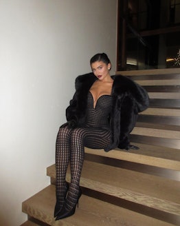 Kylie Jenner wearing a black knit Alaïa catsuit for New Year's Eve 2022.