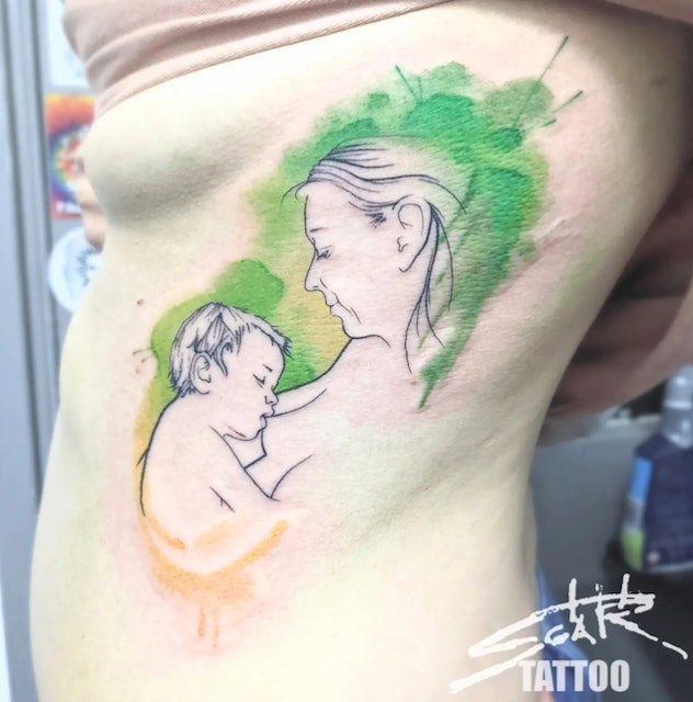 Placing your tattoo on your ribcage is one breastfeeding tattoo idea to consider.