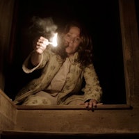 Lili Taylor holds a lit match as Carolyn Perron in 2013's The Conjuring