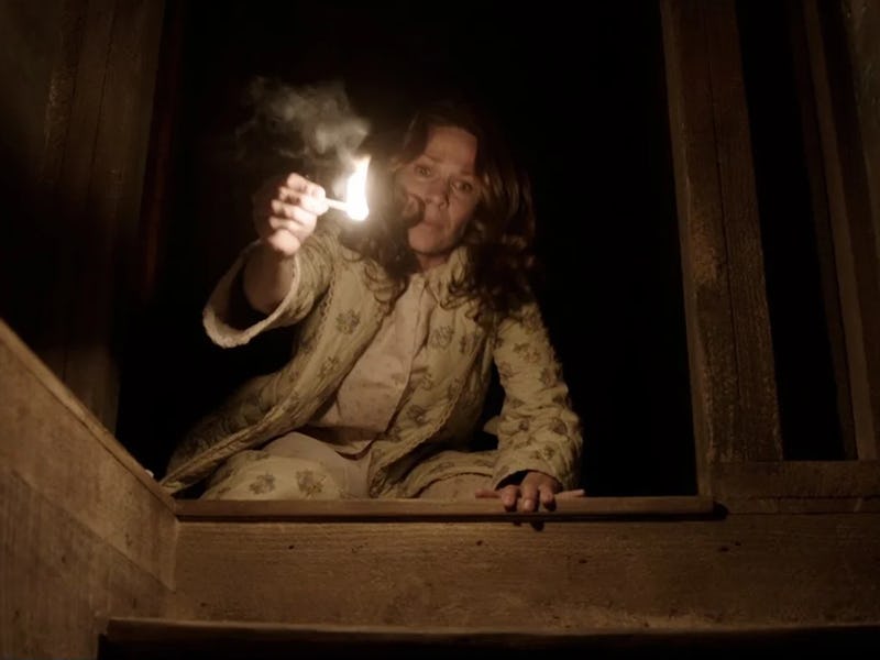 Lili Taylor holds a lit match as Carolyn Perron in 2013's The Conjuring