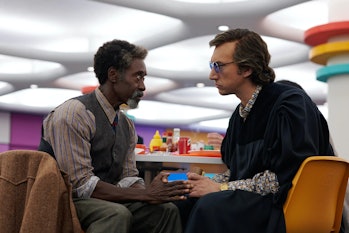Don Cheadle and Adam Driver sit at a table together in 2022's White Noise