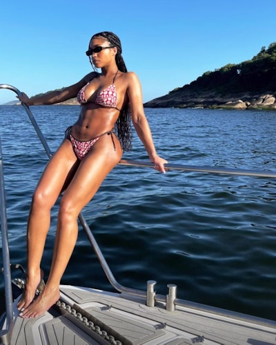 Lori Harvey wearing a bikini from the Louis Vuitton x Yayoi Kusama collab.