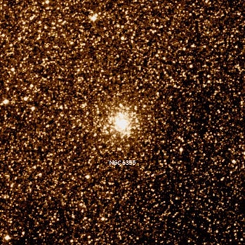 Image of a bright ball of stars surrounded by a less dense starscape in orange, yellow, and white.