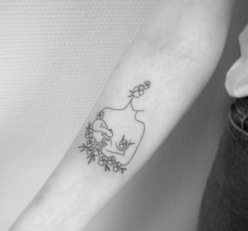 Floral accents around your tattoo is a breastfeeding tattoo idea to consider.