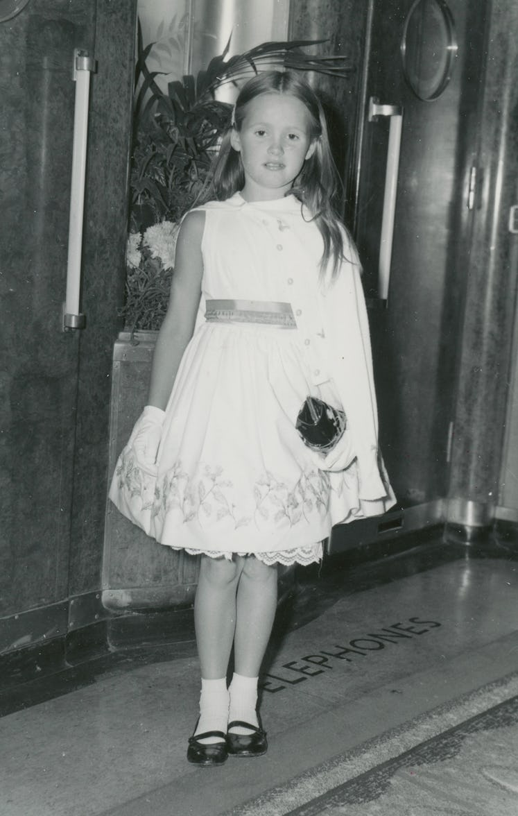 As a child, Lisa Love wore a white dress, socks, gloves, and black shoes.
