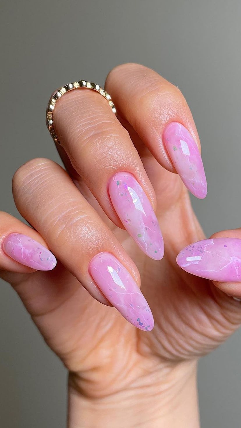 Pink marble nails are a cute pink nail design for Valentine's Day 2023.