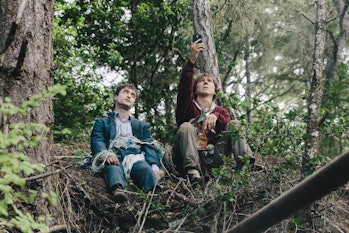 Hank (Paul Dano) and Manny (Daniel Radcliffe) sit on a hill together in 2016's Swiss Army Man