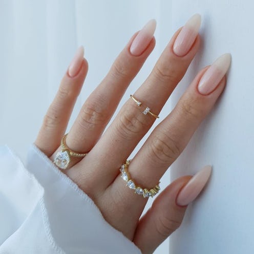 a manicured hand with long almond nails