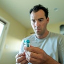 A man looks at his testosterone replacement therapy injection.
