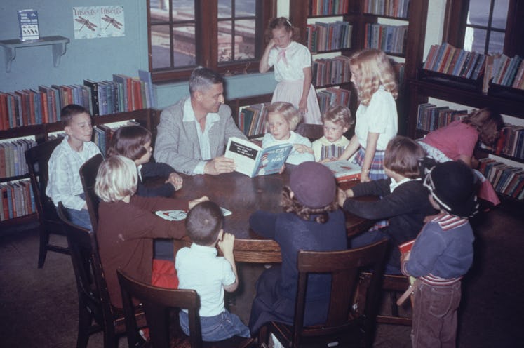 Dr. Seuss reads a book to a room full of kids.