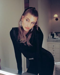 Hailey Bieber hair bow half up sexy hairstyle with black catsuit