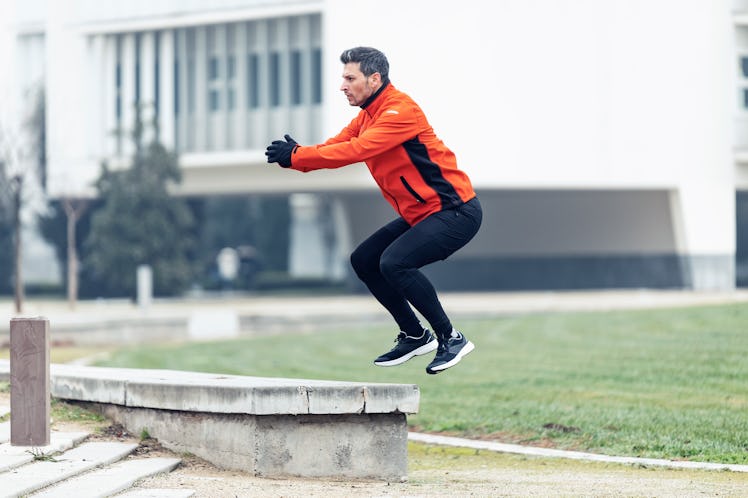 A man doing box jumps outside.