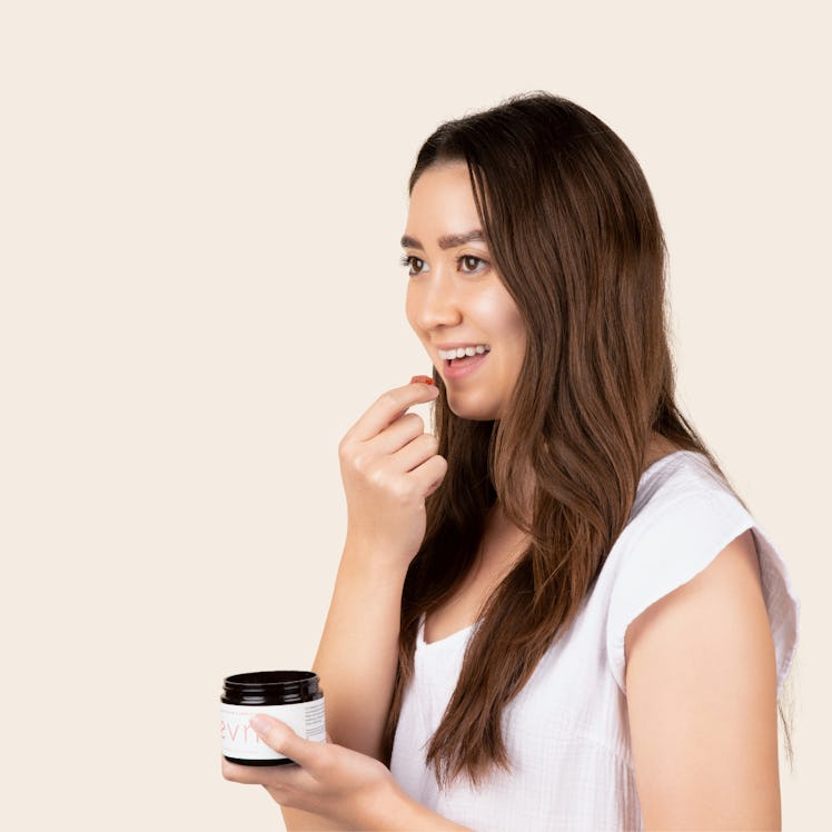 woman eating evn's strawberry gummies