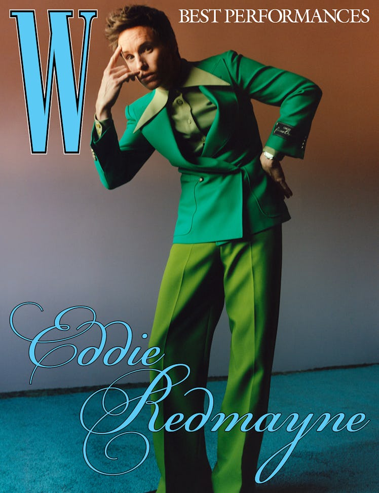 Eddie Redmayne wears a Gucci jacket, shirt, and pants; Omega watch.