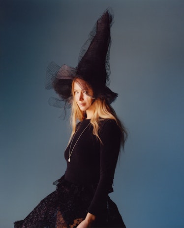 Jennifer Lawrence wears a black laced gothic gown dress, necklace and black sheer hat.