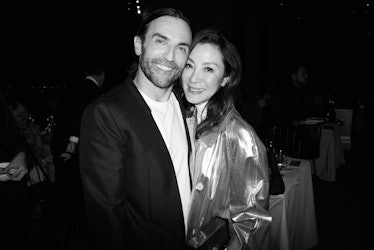Nicolas Ghesquière and Michelle Yeoh smiling and embracing
