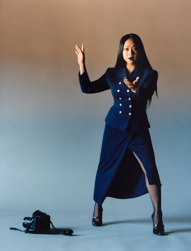 Stephanie Hsu wears a navy blue jacket, skirt and shoes.