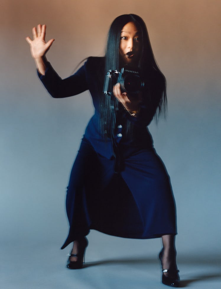 Stephanie Hsu wears a Ralph Lauren Collection jacket and skirt; Cartier watch; Wolford tights; Maiso...