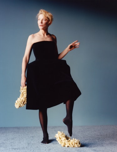 Cate Blanchett wearing a black dress & silk slippers.