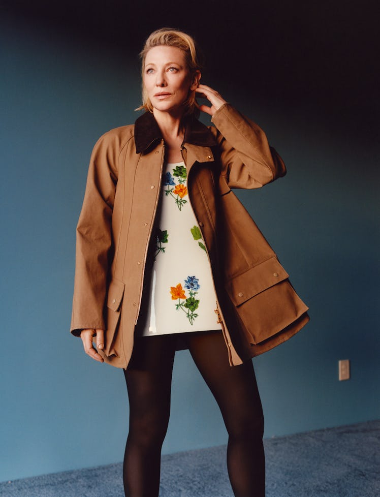 Cate Blanchett wears a brown jacket, floral top & tights.