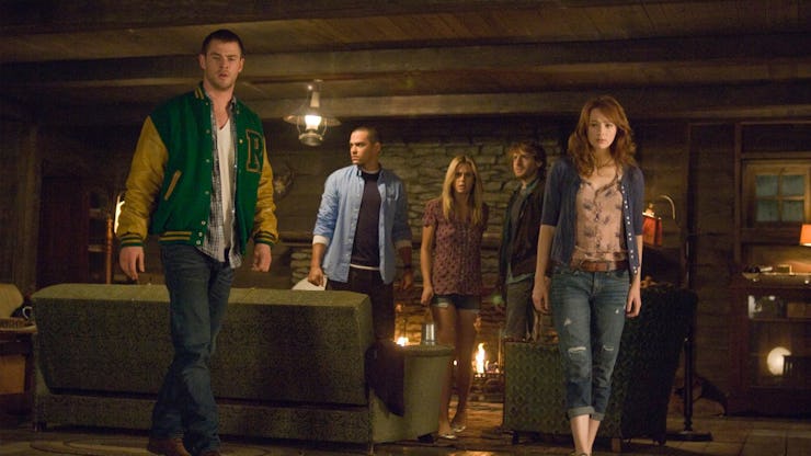 The Cabin in the Woods cast stand in a living room together