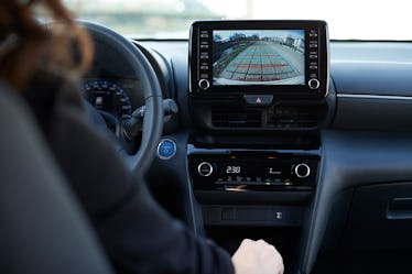 A person using the backup camera in their car.