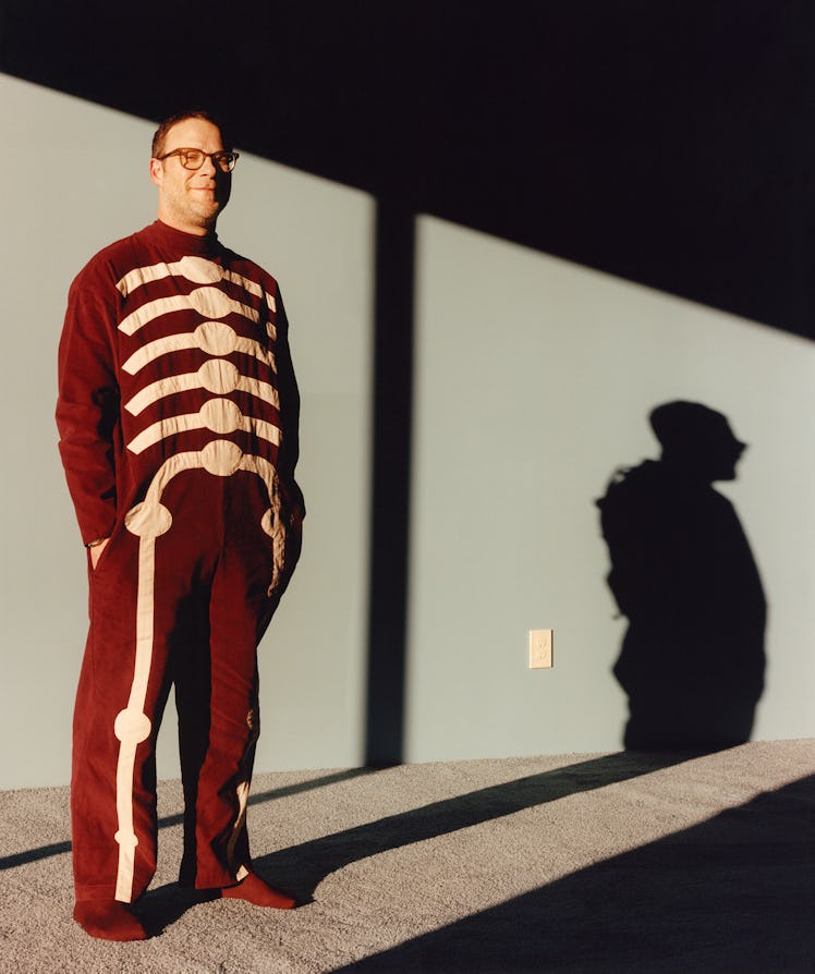 Seth Rogen wears a Bode jumpsuit; Rolex watch; Falke socks; his own glasses.