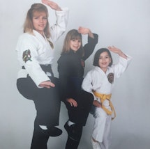 Ali Treviño-Murphy as a child with her Black Belt mom 