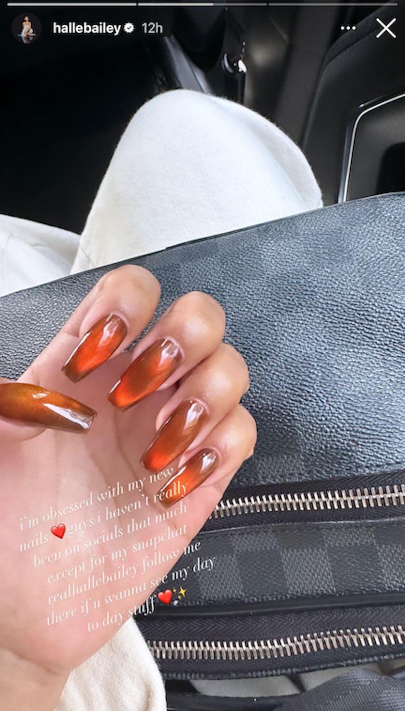 Halle Bailey's orange & chocolate brown nails combine two of fall 2023's most popular nail polish co...