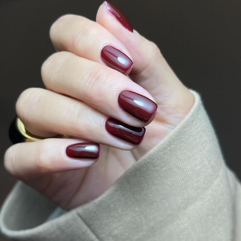 Cherry mocha, a dark red with brown undertones, is one of fall 2023's most popular nail polish color...