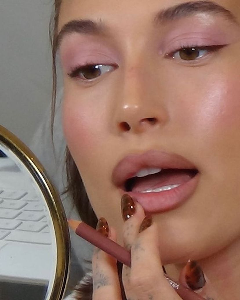 Hailey Bieber's chocolate brown nail polish is a major manicure trend for fall 2023.