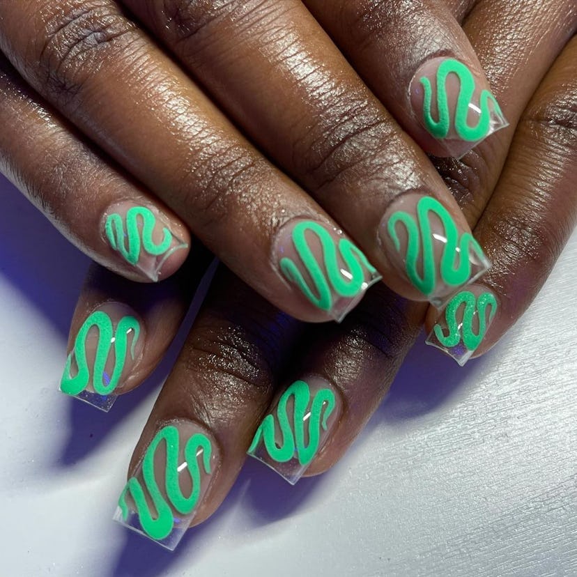 If you need manicure inspo, neon green swirls are a simple nail design for short nails that's trendy...