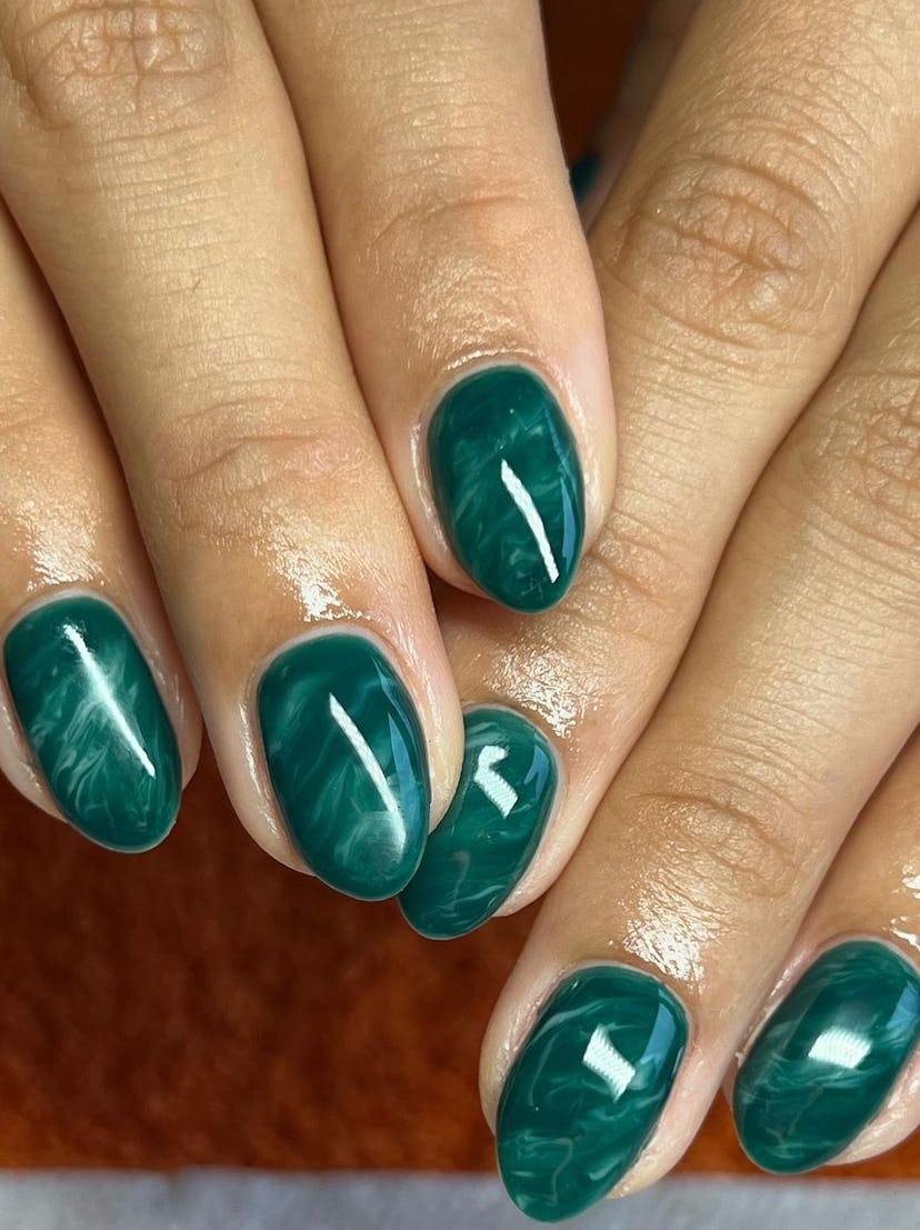 Emerald green is one of fall 2023's most popular nail polish color trends.