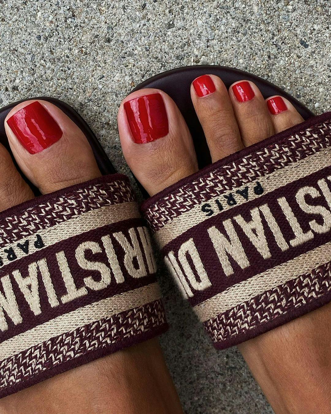 Trend experts predict red toe nail polish will be a popular fall 2023 pedicure color trend.