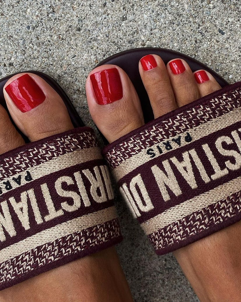 Trend experts predict red toe nail polish will be a popular fall 2023 pedicure color trend.