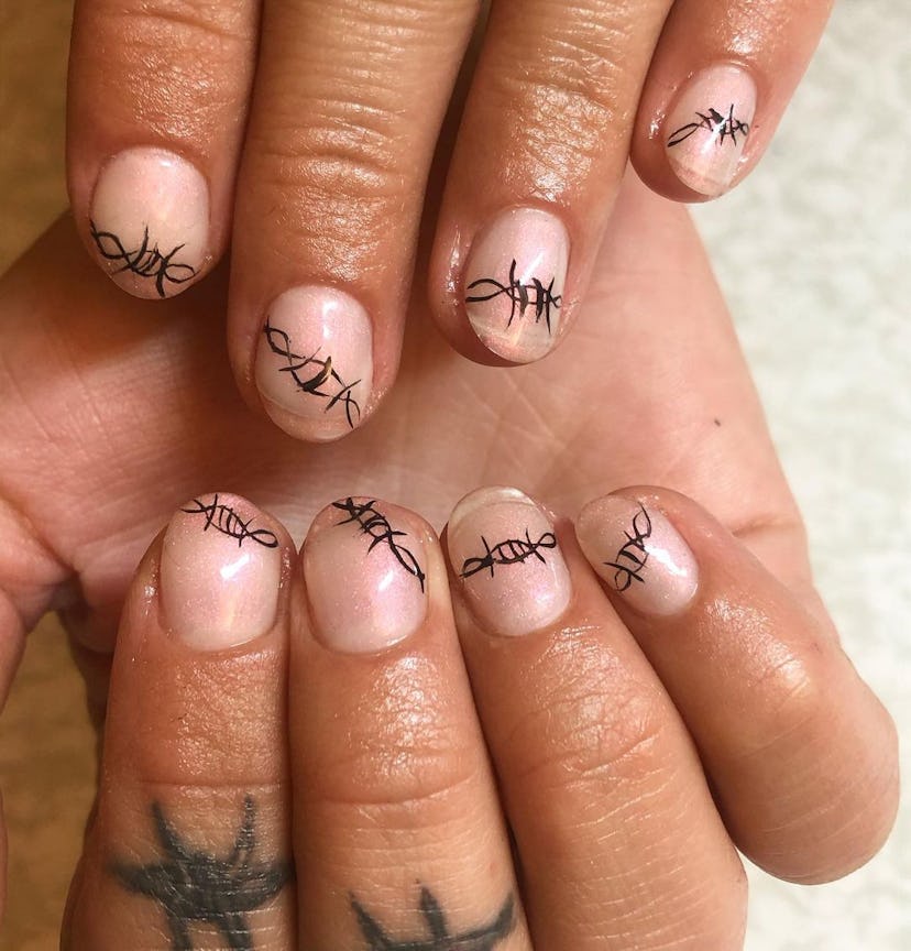 If you need manicure inspo, barbed wire nail art is a simple nail design for very short nails.