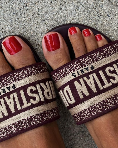 Trend experts predict red toe nail polish will be a popular fall 2023 pedicure color trend.