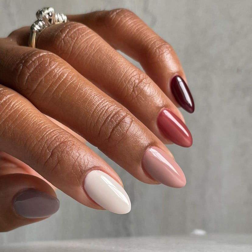 For fall 2023 manicure inspo, a skittles manicure in neutral colors is a simple nail design for very...