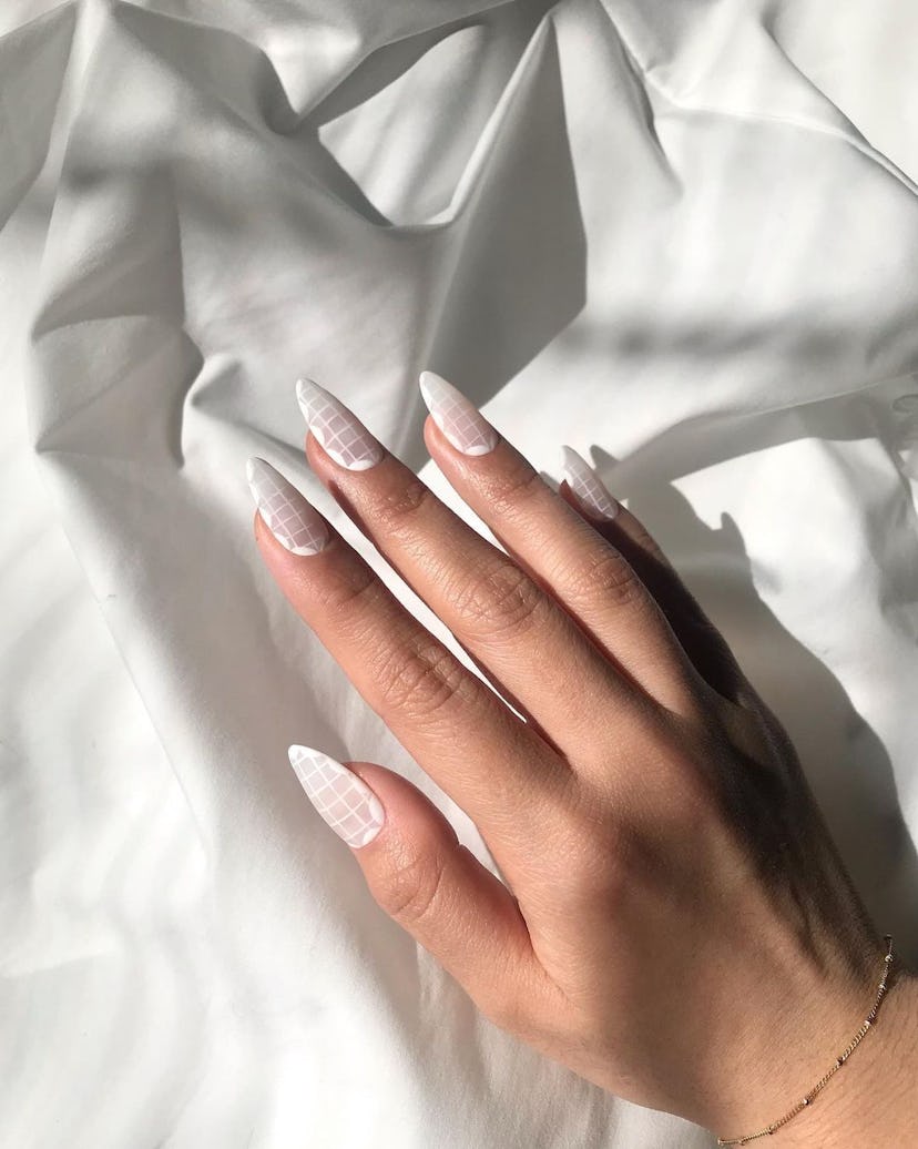 A trendy & simple white checkered nail art design.