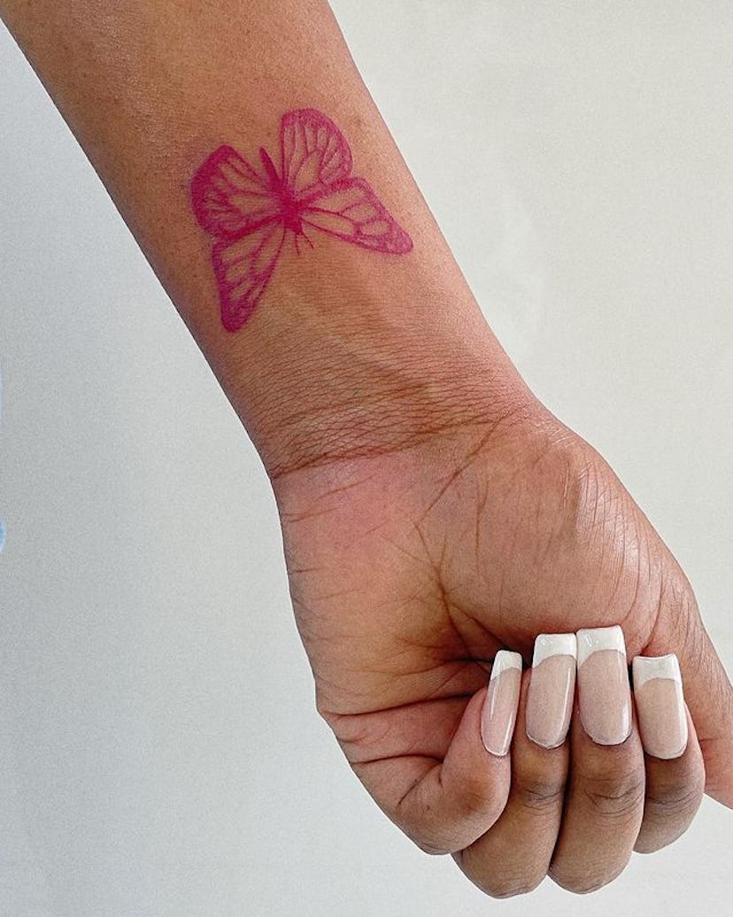 Red ink butterfly tattoo.