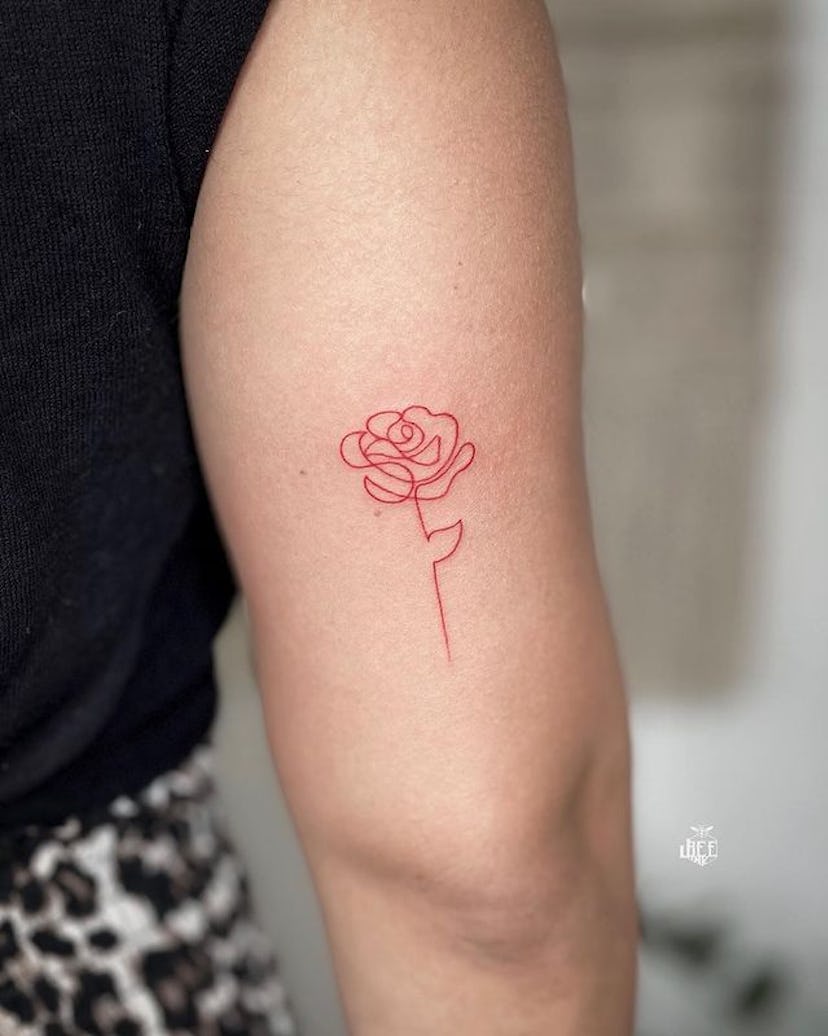 Red ink rose tattoo.