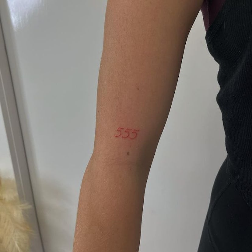 Red ink tattoo angel numbers.
