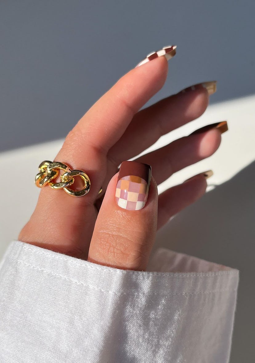 A trendy neutral nail art design for square-shaped short nails that combines brown checkered nail ar…