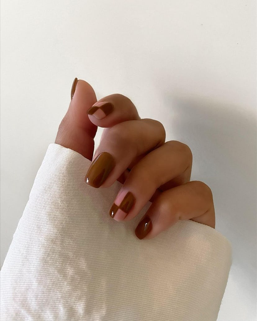 A simple brown checkered nail design for short nails.