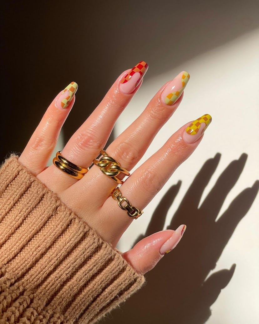 A trendy checkered nail design for 2023.