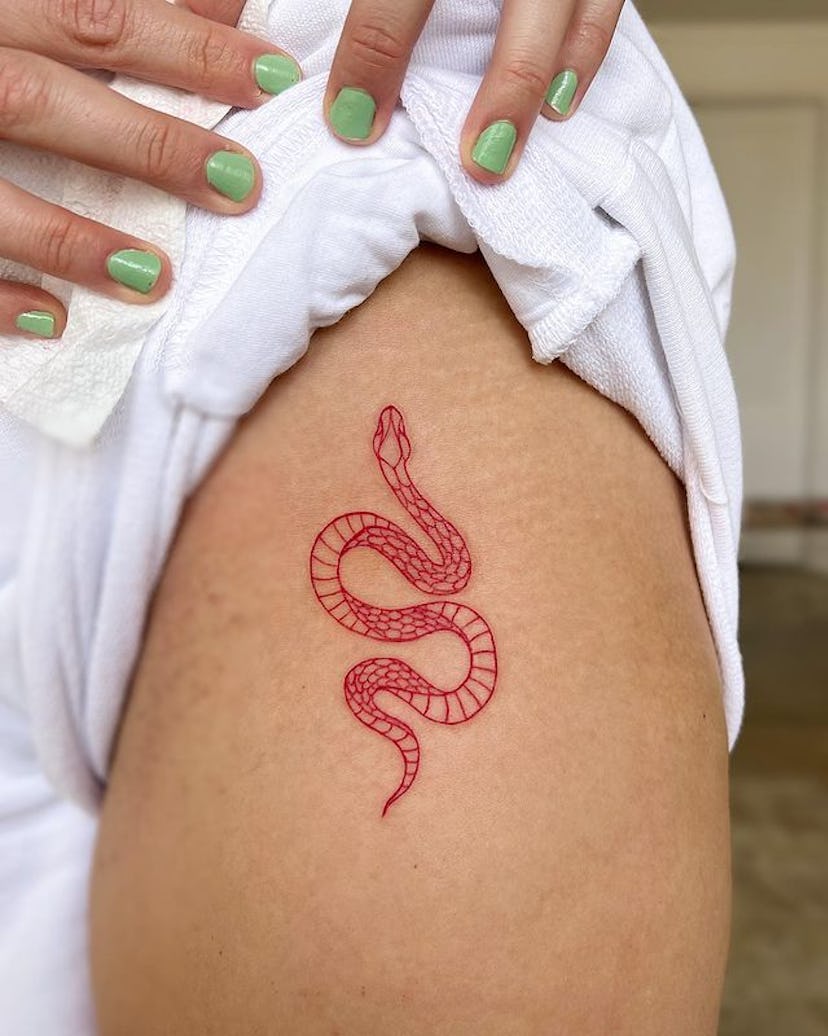 Red ink snake tattoo.