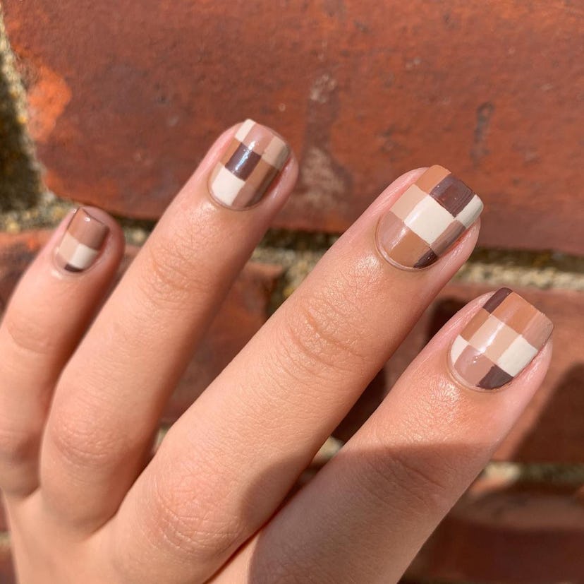 A trendy brown checkered nail design for short nails for 2023.