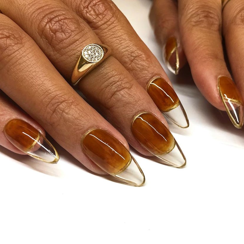 Clear nails with a burnt orange nail polish base are a cute pumpkin-inspired nail art design idea fo…